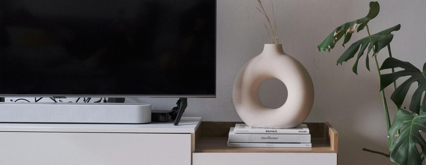 a tv on a stand with decor